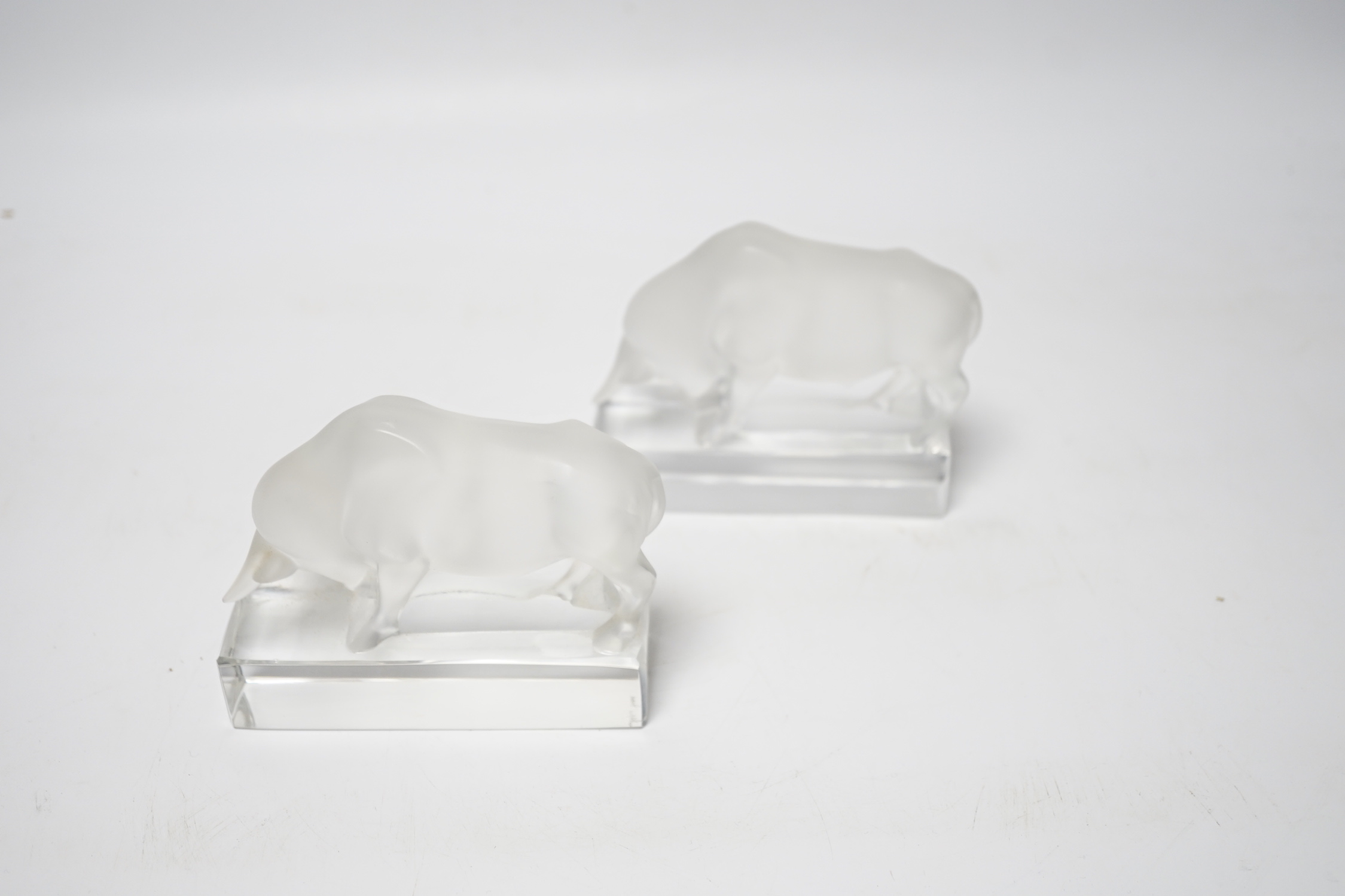 Rene Lalique, two frosted glass paperweights modelled as a bull, signed ‘Lalique France’ to base, 9cm high